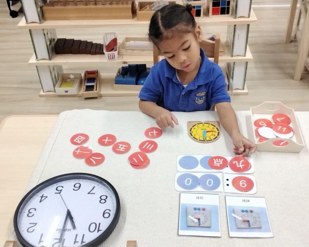 Student working with Montessori clock materials